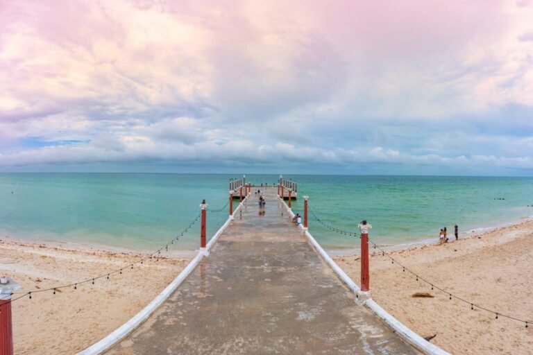 Pier in Sisal, Mexico over emerald waters
