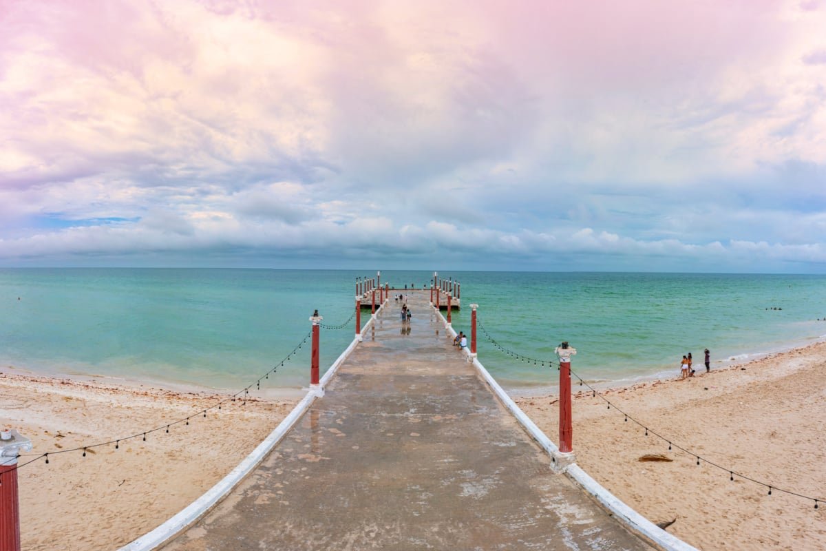 Pier in Sisal, Mexico over emerald waters