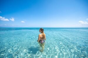 Woman in crystal-clear waters in Sardinia