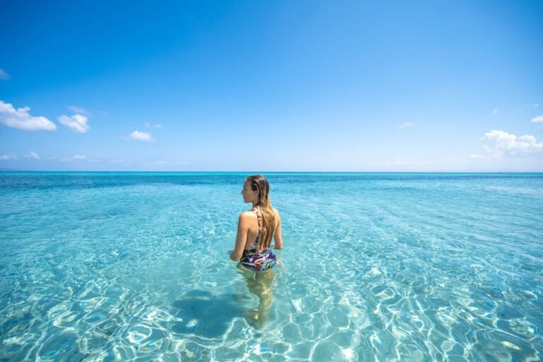 Woman in crystal-clear waters in Sardinia