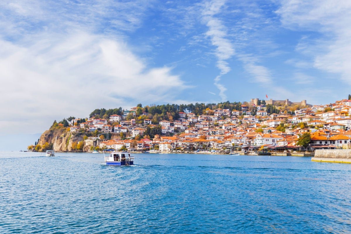 Boats riding by townscape of Lake Ohrid, North Macedonia