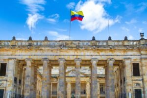 Colombia flag waving over historic building in Bogota
