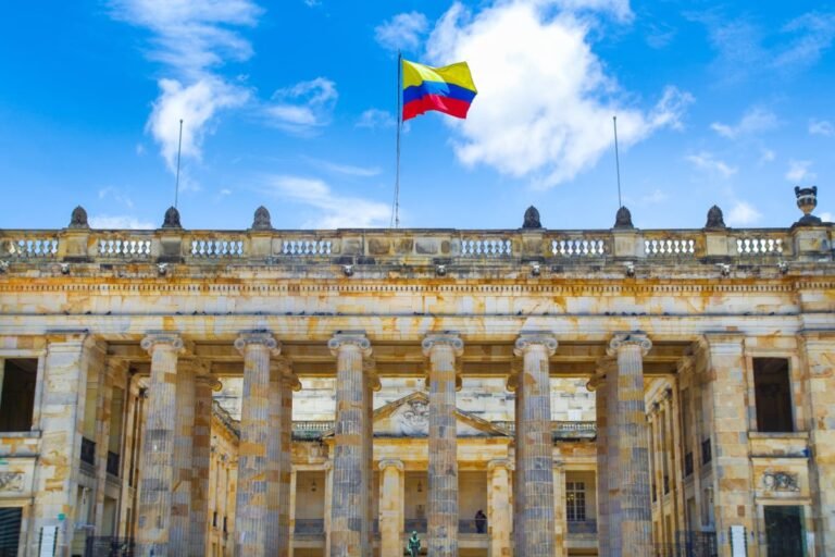 Colombia flag waving over historic building in Bogota