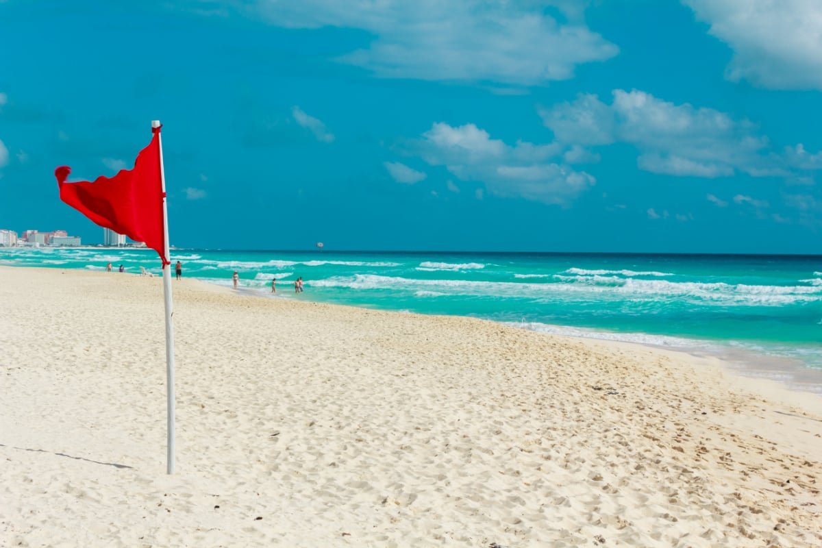 Red flag on a pristine cancun beach